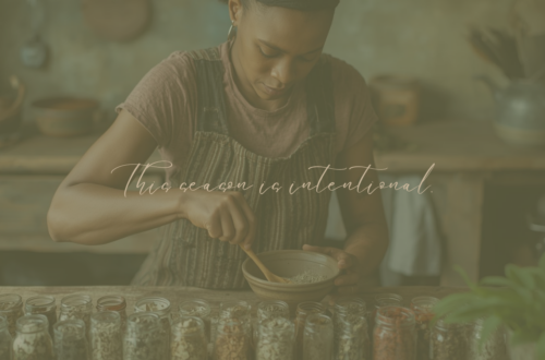 African American woman mixing dried herbs in a bowl at a kitchen table.
