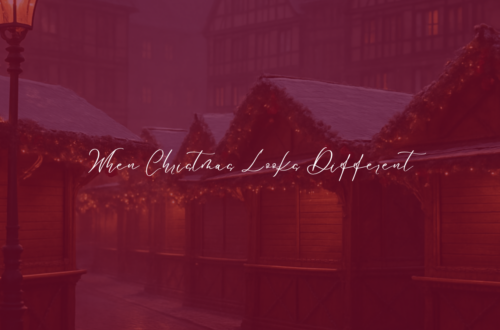 Empty German Christmas market with softly lit wooden stalls, snow-dusted rooftops, and warm holiday lights creating a quiet, reflective winter atmosphere.