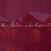 Empty German Christmas market with softly lit wooden stalls, snow-dusted rooftops, and warm holiday lights creating a quiet, reflective winter atmosphere.